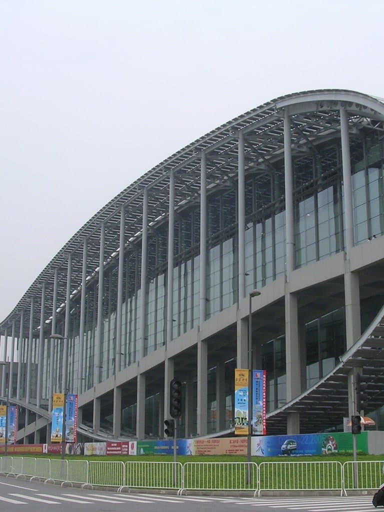 The curved glass front of an exhibition hall at the Canton Fair Complex